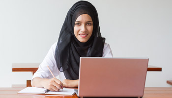 Woman in head dress studying